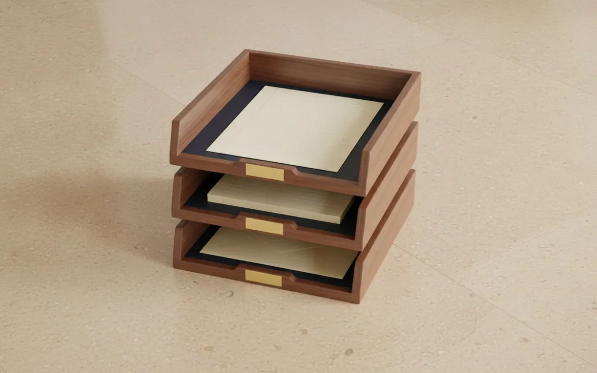 A walnut letter tray with three stacked compartments, one for each level of authority.